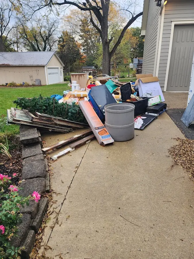 Dumpster being loaded with debris for 12 Yard Dumpster Rental in Volney